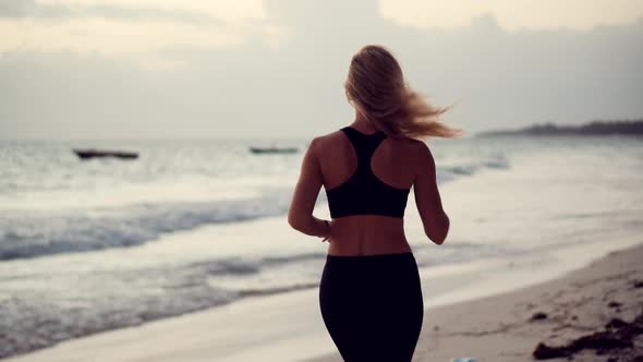 Triathlete Run Before Triathlon Competition. Running Woman Workout. Runner Workout On Beach.