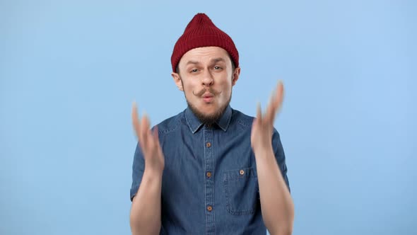 Portrait of Confused Man 20s Wearing Hat Gesturing and Screaming Why in Resentment Isolated Over
