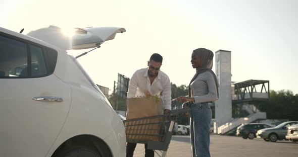 African Arabian Couple Pack Grocery in a Car