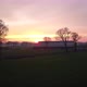 Aerial Footage By a Drone Flying Low Over a Beautiful Sunset Farm Field Warm Light Sun - VideoHive Item for Sale