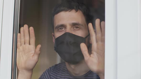 Man in Protective Mask Behind the the Window