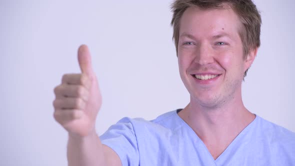 Face of Happy Young Man Patient Giving Thumbs Up