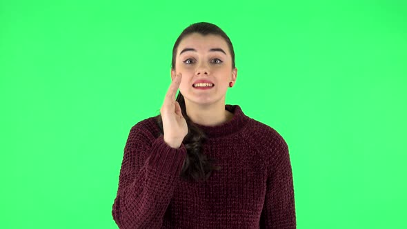 Girl Screams Calling Someone on a Green Screen at Studio. Green Screen