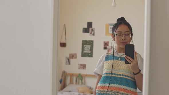 Asian Teenage Girl Taking Selfie Portraits in Mirror