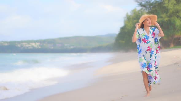 Asian woman enjoy around beautiful beach sea ocean