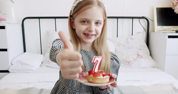 A Birthday Party for a Happy Cute 7 Year Old Girl and Shows the Like Sign