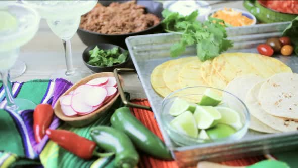 Ground beef tacos with romaine lettuce, diced tomatoes, radishes, and shredded cheddar cheese.