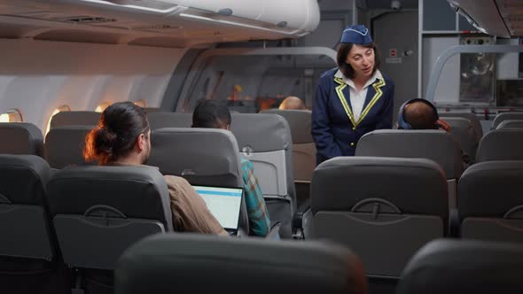 Flight Attendant Assisting Passengers to Board on Airplane