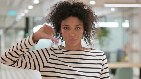 Disappointed African Woman Doing Thumbs Down