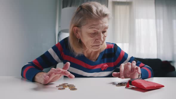 Poor Old Woman Counting Coins on the Table