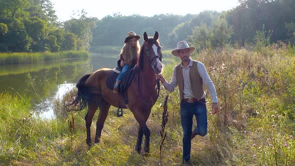 Cowboy and His Daughter on Horseback
