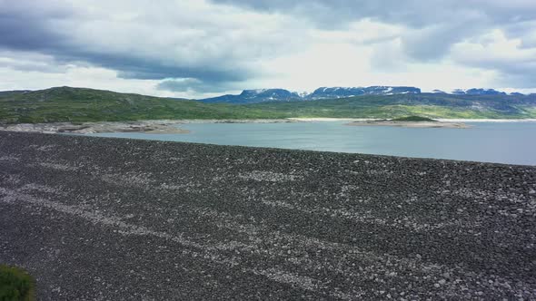 Approaching water reservoir dam for hydroelectric powerplant - Sysendammen Norway - spectacular view