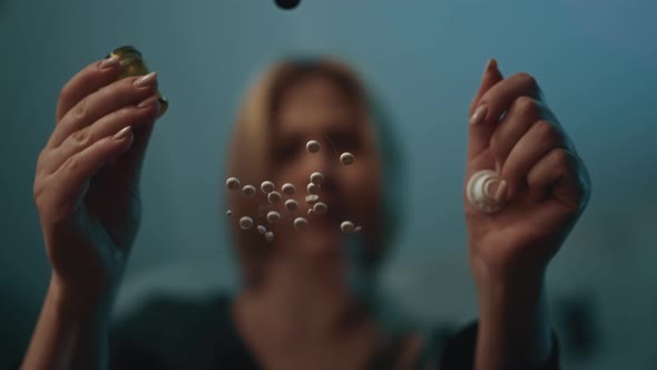 Woman with Addiction Sits at Table with Scattered Tablets