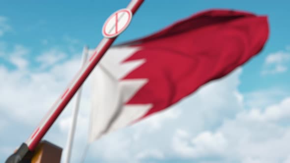 Closed Boom Gate with No Immigration Sign at the Flag of Bahrain alt