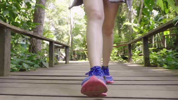 Legs Walking On Wooden Walk Way