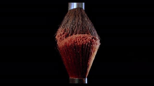 Two Make-up Brush with Powder on Black Background with Sunlight Colour Paint Concept Slow Motion. V2