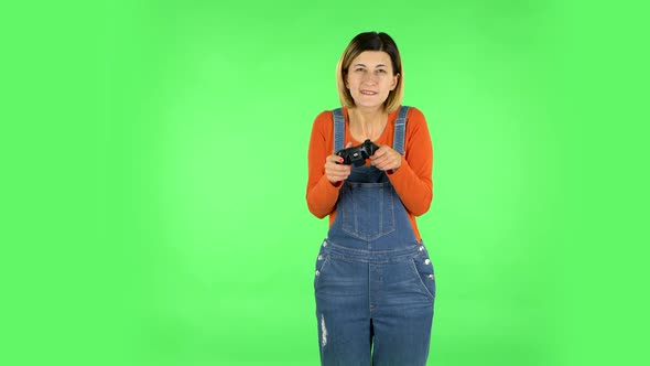 Girl Playing a Video Game Using a Wireless Controller with Joy and Wow Emotions. Green Screen