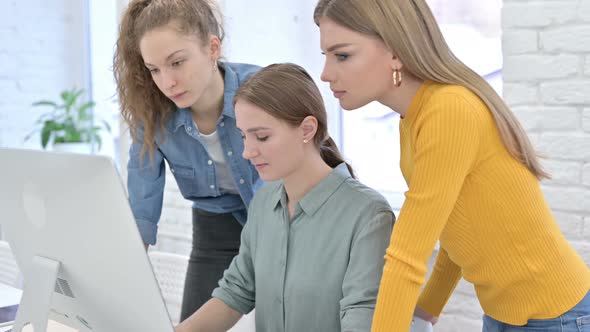 Hardworking Young Startup Team Celebrating Success on Desktop