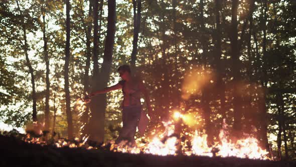 Person rotating with fire in the woods, Ultra Slow Motion