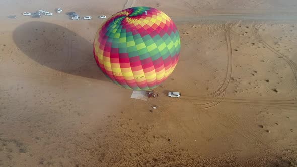 Aerial view of an hot-air-balloon being filling in the Murqquab desert, Dubai.