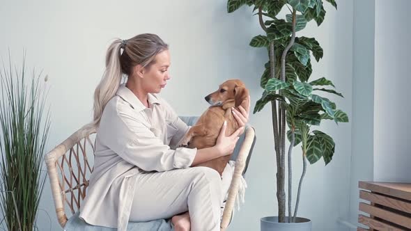 Young Beautiful Blonde Woman Caucasian Nationality Home Clothes Sits Cozy Chair Embrace with Her