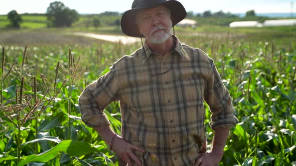 Close up push in to farmer in field looking at camera at sunlight agriculture farm fharvest garden n