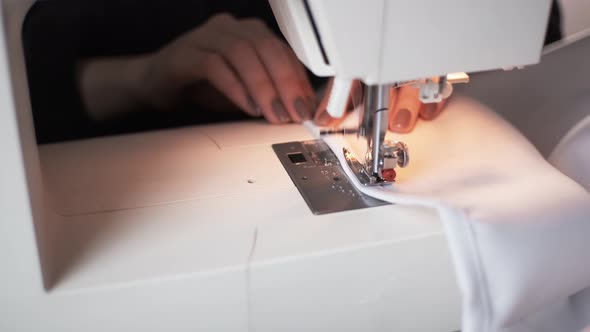 Female Tailor Works on Sew Machine