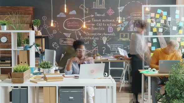 Time Lapse of Diverse Group of Businesspeople Working in Creative Office Talking