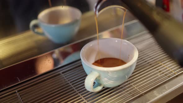 a Light Blue Mug Stands in a Professional Coffee Machine and a Beautiful Hot Fragrant Espresso