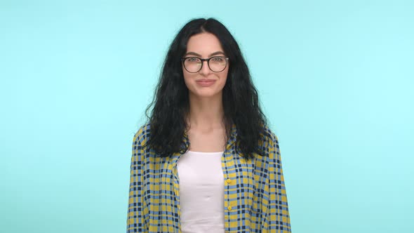 Slow Motion of Beautiful and Happy Brunette Woman in Glasses Starts to Smile Looking at Camera with