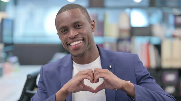 Portrait of African Businessman Showing Heart Sign By Hand