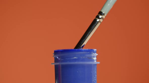 Blue Paint Isolated on Orange Background