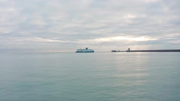 Low aerial drone shot towards Dover to calais cross channel ferry leaving dover harbour