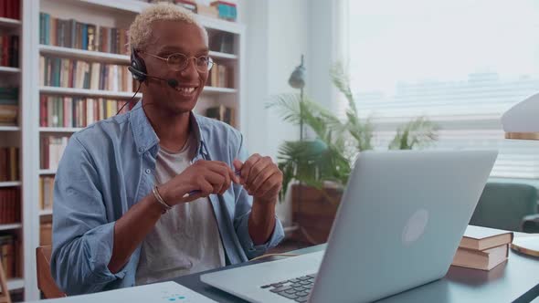 Smiling Customer Support Operator with Handsfree Headset Working in the Office