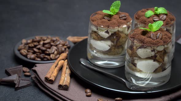 Classic Tiramisu Dessert in a Glass on Dark Concrete Background