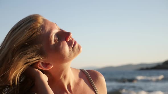 Close-up of beautiful blond female by the sea    slow-mo 1920X1080 HD footage - Slow motion of enjoy