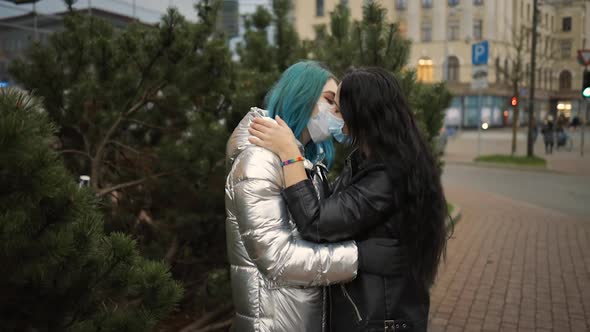 LGBT Female Couple Kiss in Medical Face Masks