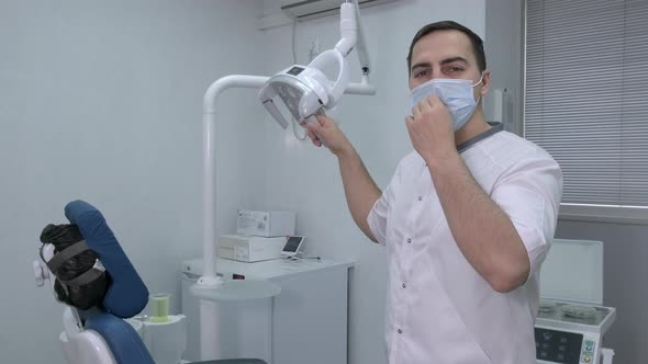 Dentist Taking Off His Protective Mask and Smiling in Dental Office