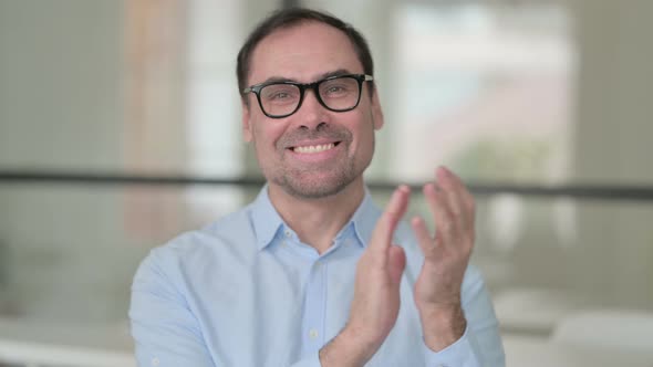 Portrait Shot of Happy Middle Aged Man Clapping Applauding