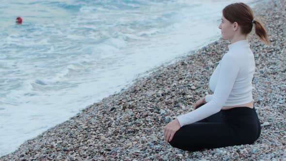 Sports Outdoors  a Fitness Woman Doing Yoga By the Sea