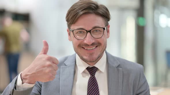 Portrait of Positive Businessman Doing Thumbs Up 