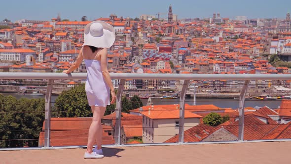 Young Woman Tourist Enjoying Cityscape of Porto.