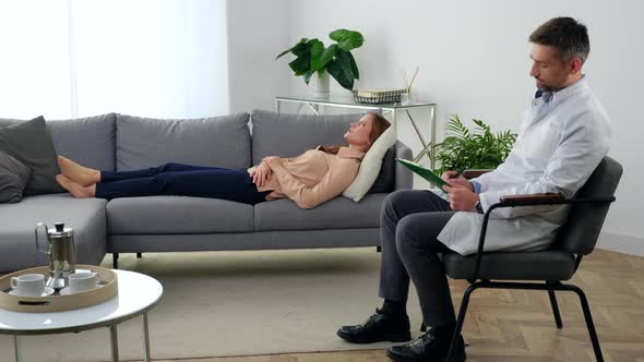 Adult Woman with Mental Health Problems Lying on Couch Talking to Therapist