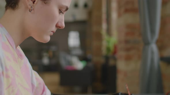 Girl with Prosthetic Arm Painting Picture at Home