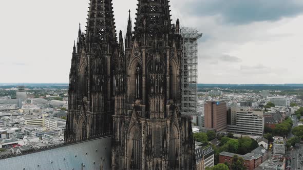 Circling the historical Cologne Cathedral during it's renovation construction in Cologne, Germany 4K