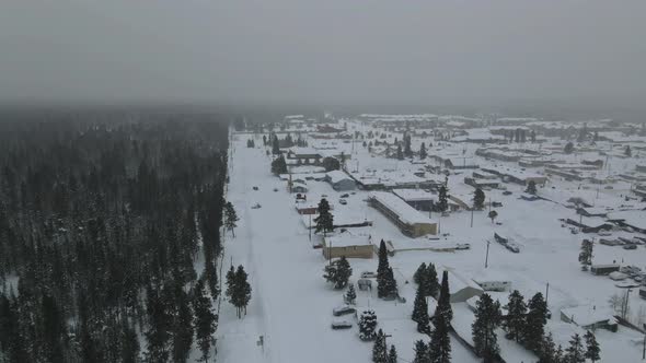Aerial View of the Residential Districts in Small Town of on a Snowy Winter Day Near Forest