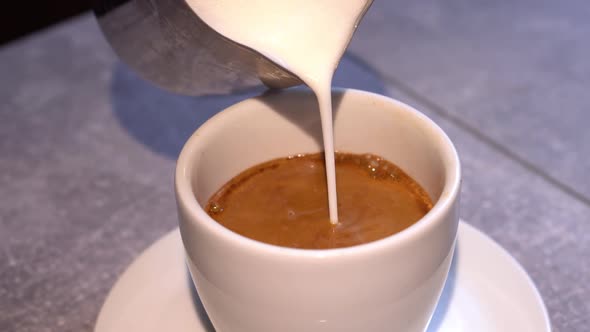 Preparation Process of Coffee with Shaked Up Milk  Latte or Cappuchino in White Cup