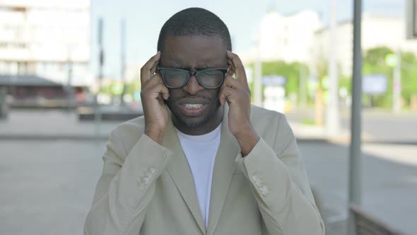 Portrait of African Man Having Headache Outdoor