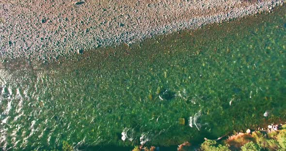 Low Altitude Flight Over Fresh Fast Mountain River with Rocks at Sunny Summer Morning