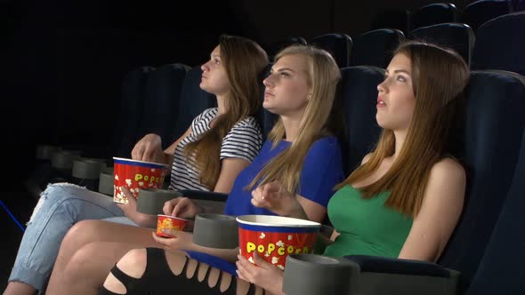 Girl Watching a Film at the Cinema and Eat, Eating Popcorn